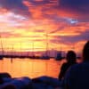 Silhouettes of people watching the sunset - sunset traditions