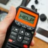 Person holding a radio with the word "help" on the display - getting help for a boat emergency