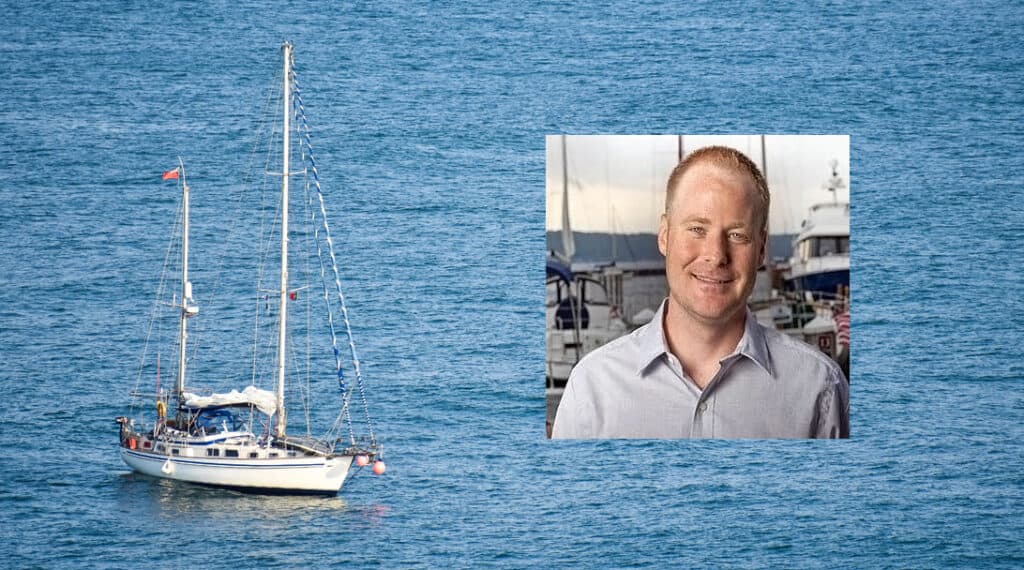 Boat at anchor with inset picture of man with red hair and grey shirt