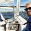 sailboat with white haired main on the left and man with beard on the right - how to learn about your boat