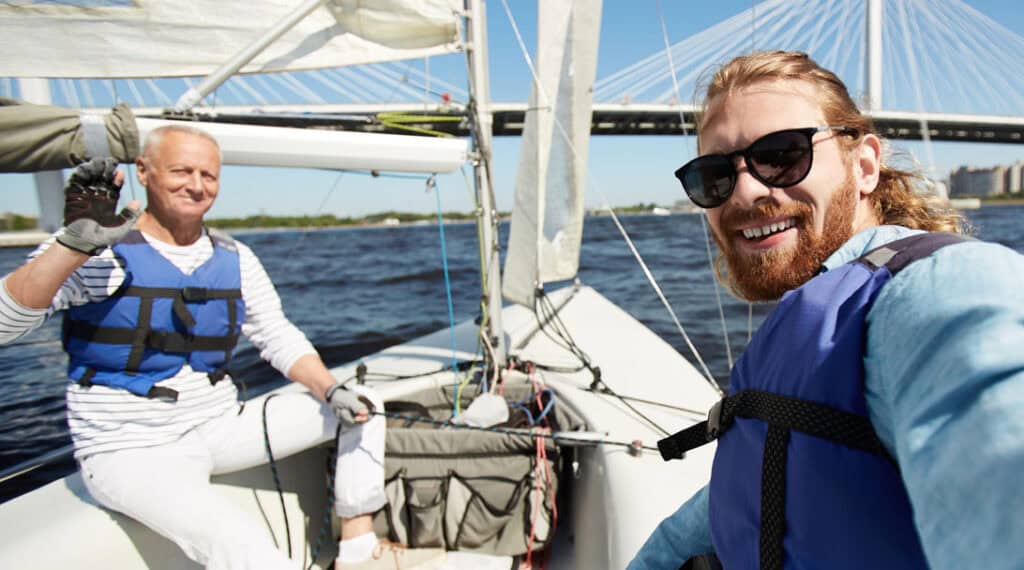 sailboat with white haired main on the left and man with beard on the right - how to learn about your boat