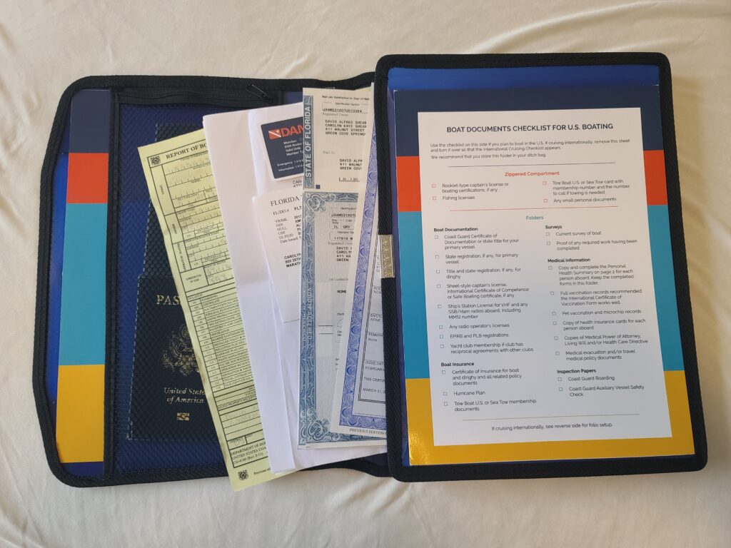 Open Boat Documents Organizer holding registration, certificate of documentation and passport, US boating checklist on the right