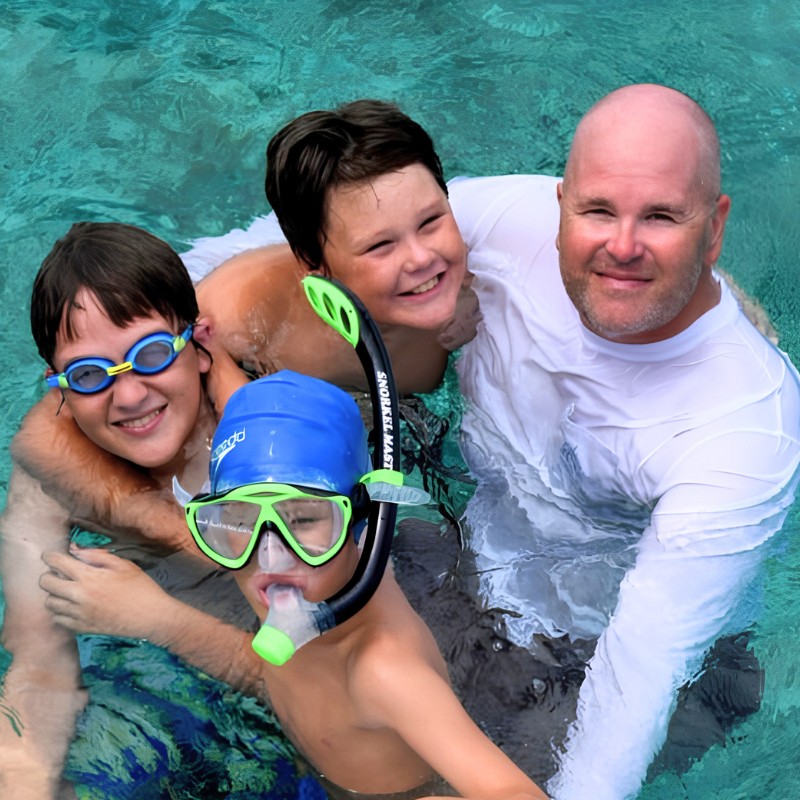 Dad and three kids getting ready to snorkel