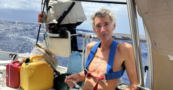 Man eating fish in sailboat cockpit - Pacific Passage Highlights