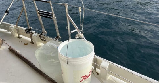 bucket on a boat deck catching rainwater