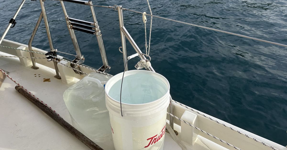 bucket on a boat deck catching rainwater