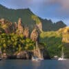 Boat anchored with mountains in the background - provisioning in the Marquesas