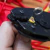 Hand holding a crimping tool and a wire - Tips for Boat Wiring