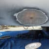 Boat hull on the hard showing ground-out area being filled in with fiberglass and epoxy