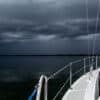 sailboat anchored under a dark sky