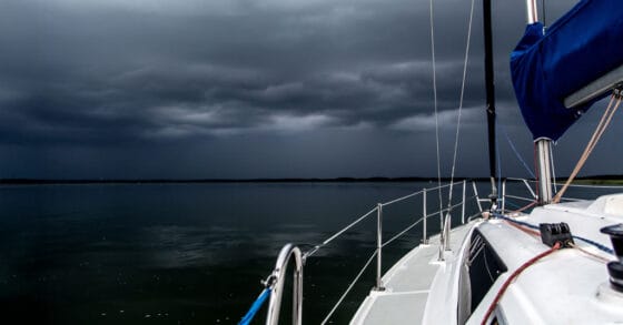 sailboat anchored under a dark sky