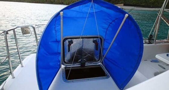 Blue Breeze Booster freestanding wind scoop installed over a boat hatch on a catamaran deck