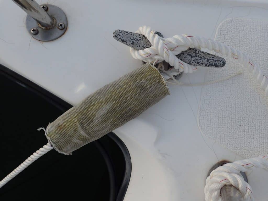 Fire hose chafe gear correctly tied into place to protect mooring lines.