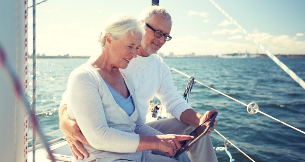 Older couple on the bow of a sailboat