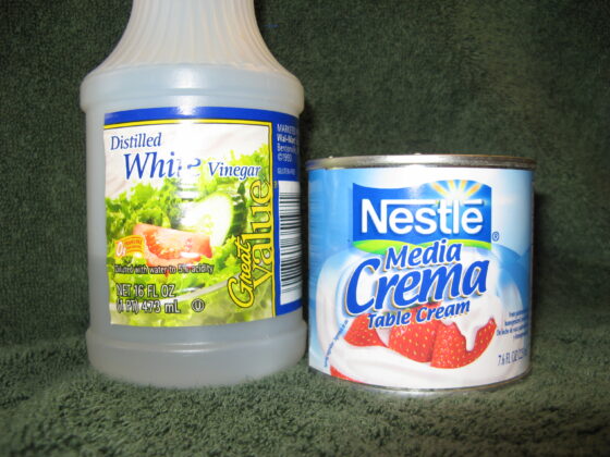 Can of Nestle media crema and bottle of white vinegar, the shelf-stable ingredients for making sour cream without refrigeration
