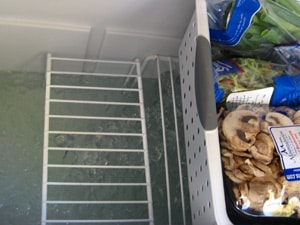 Wire shelving lifts the food out of the melting ice water and the plastic bins keep the food tidy and dry.