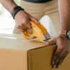 Man taping box closed - organizing to move aboard a boat