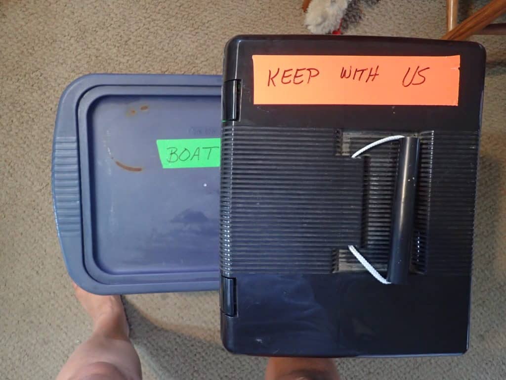 Stacked and labeled cardboard moving boxes sorted by destination before moving aboard a boat