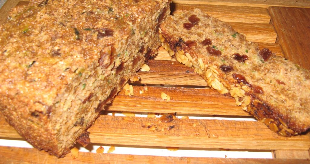 Homemade zucchini bread on a cutting board, sliced