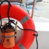 orange safety buoy on a boat rail