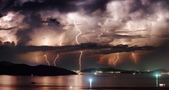 Multiple lightning strikes over a calm anchorage at night, showing the real threat to boat electronics